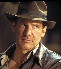 Back From Yet Another Globetrotting Adventure, Indiana Jones Checks His Mail And Discovers That His Bid For Tenure Has Been Denied.